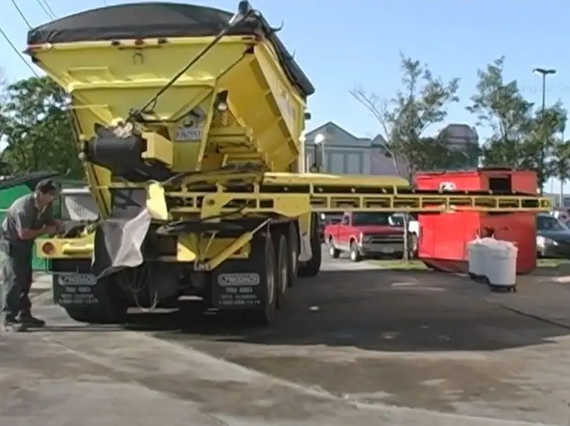 Peterson sand pumping truck and conveyor set up in a parking lot